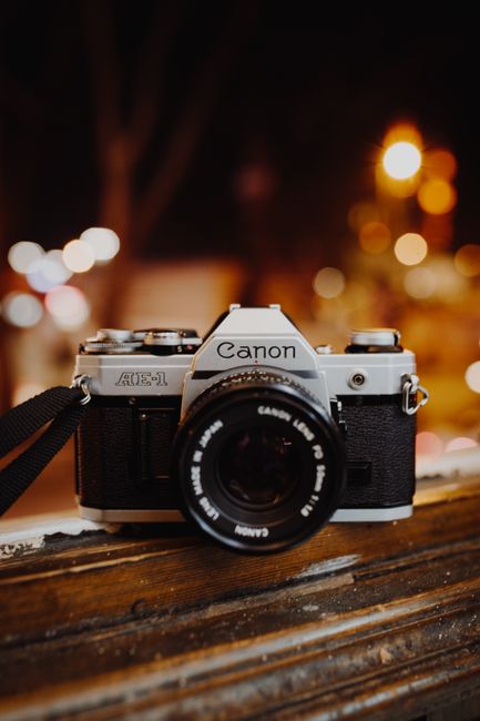 Close-up of a vintage Canon AE-1 camera with bokeh background.