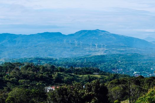 Scenic view of wind turbines on lush mountains in Antipolo, Calabarzon, Philippines.