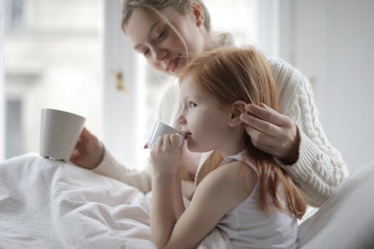 A mother and daughter enjoying a cozy moment indoors with warm drinks, surrounded by comfort and love.