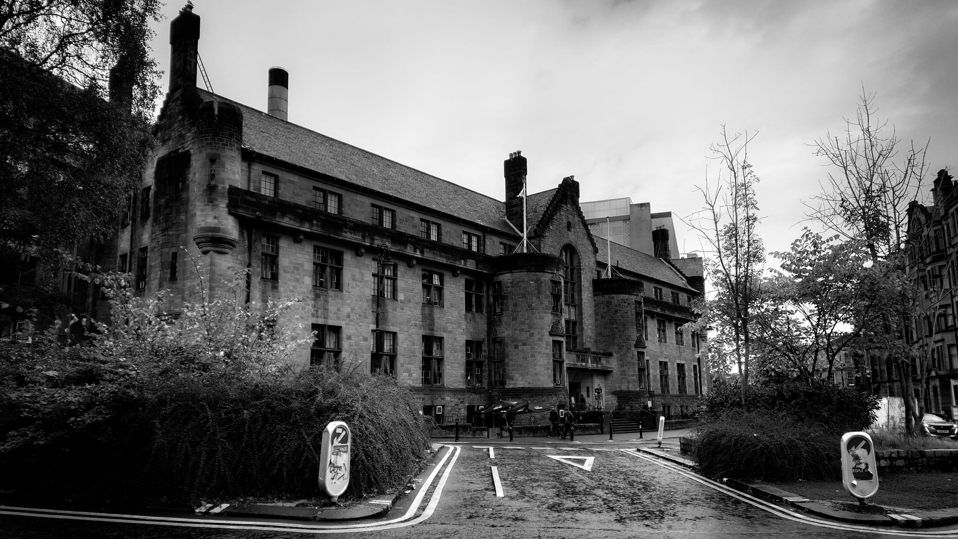 Monochrome image of a historic stone building on a cloudy day, showcasing classic architecture.