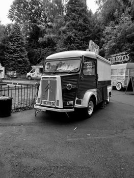 Classic Citroën truck in black and white at an outdoor festival setting.