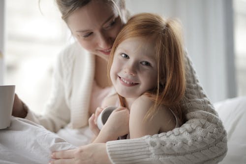 Photo Of Woman Embracing Girl