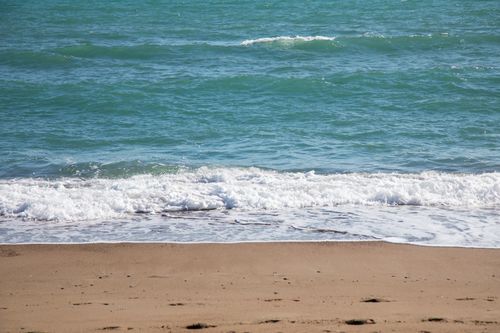 Free Peaceful beach scene in Turkey with calming waves and golden sand. Stock Photo