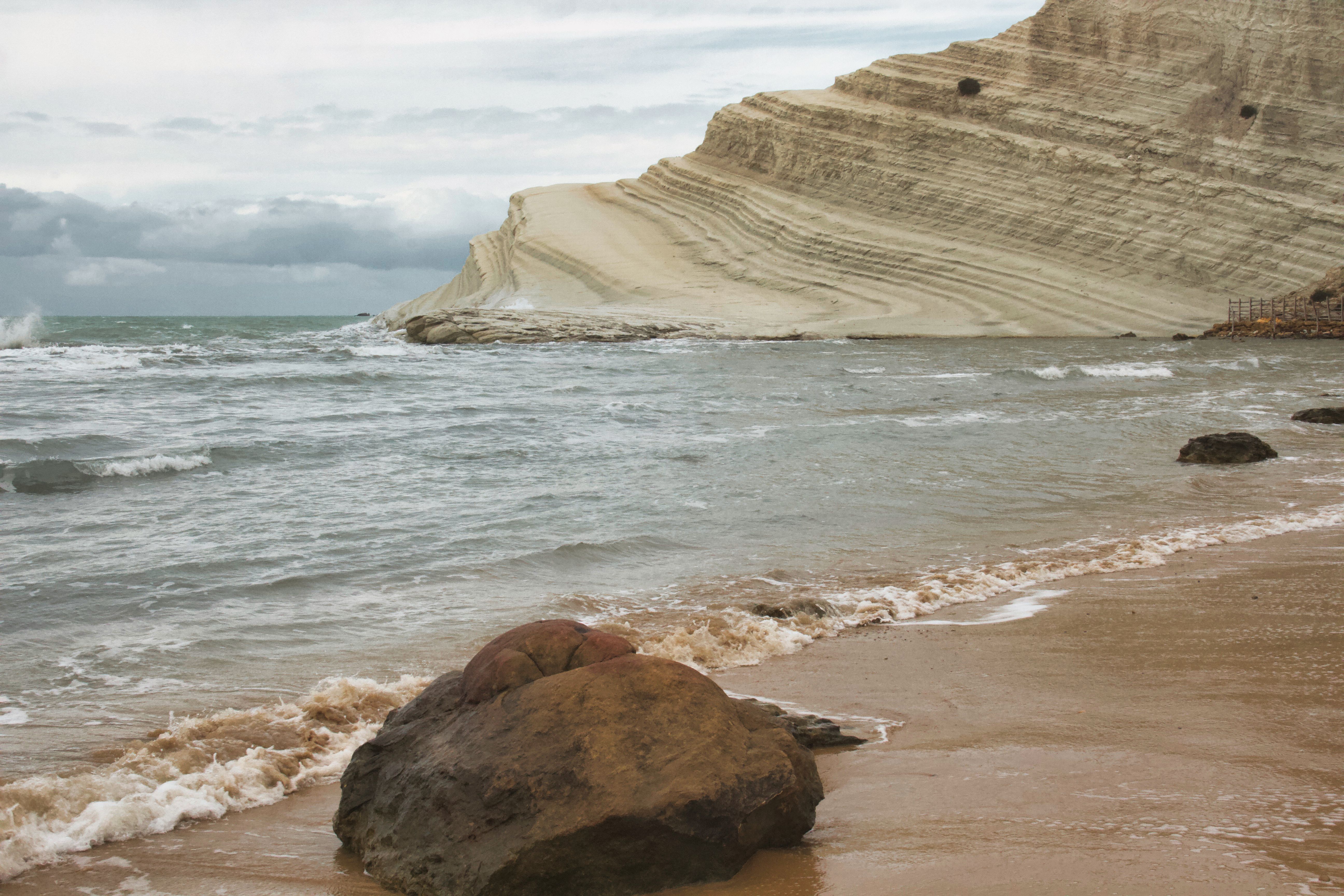 Breathtaking view of Scala dei Turchi's iconic white cliff and beach in Sicily, Italy.