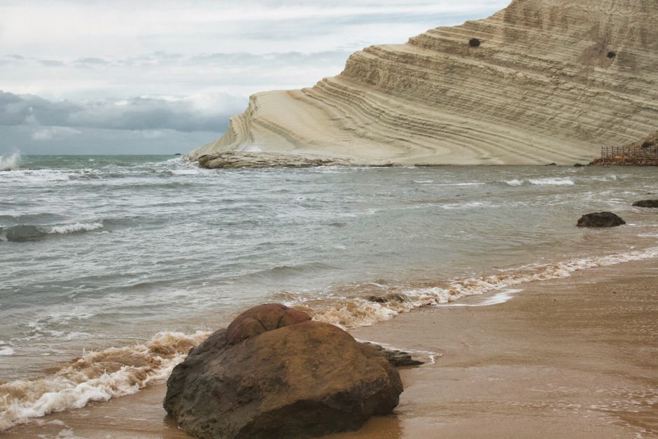 Breathtaking view of Scala dei Turchi's iconic white cliff and beach in Sicily, Italy.