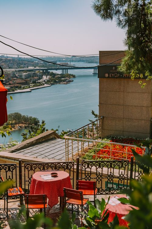Free Charming outdoor cafe with red tablecloths overlooking the Bosphorus in Eyüp, Istanbul. Stock Photo
