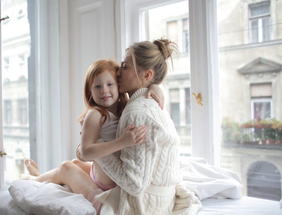 Free Photo Of Woman Kissing Child Stock Photo