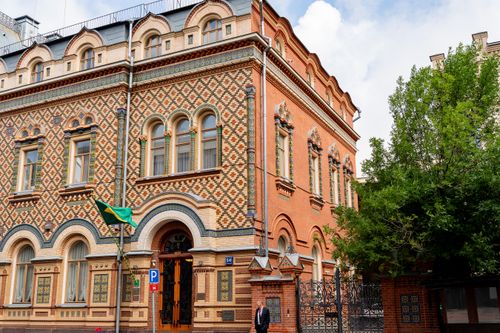 Free Ornate brick building with a unique mosaic facade in a city setting. Stock Photo