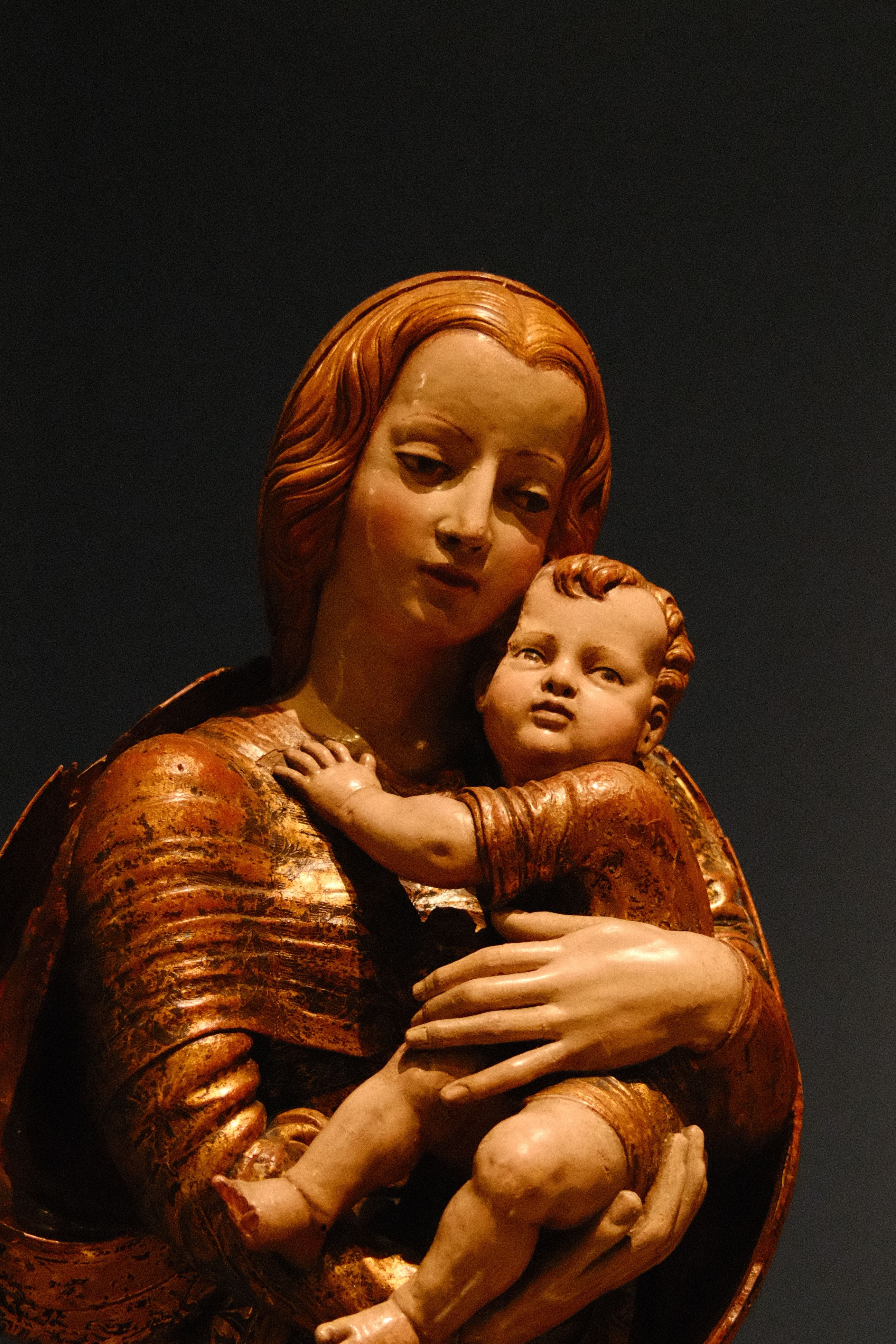 Detailed view of a Renaissance sculpture depicting Madonna and Child with intricate details.