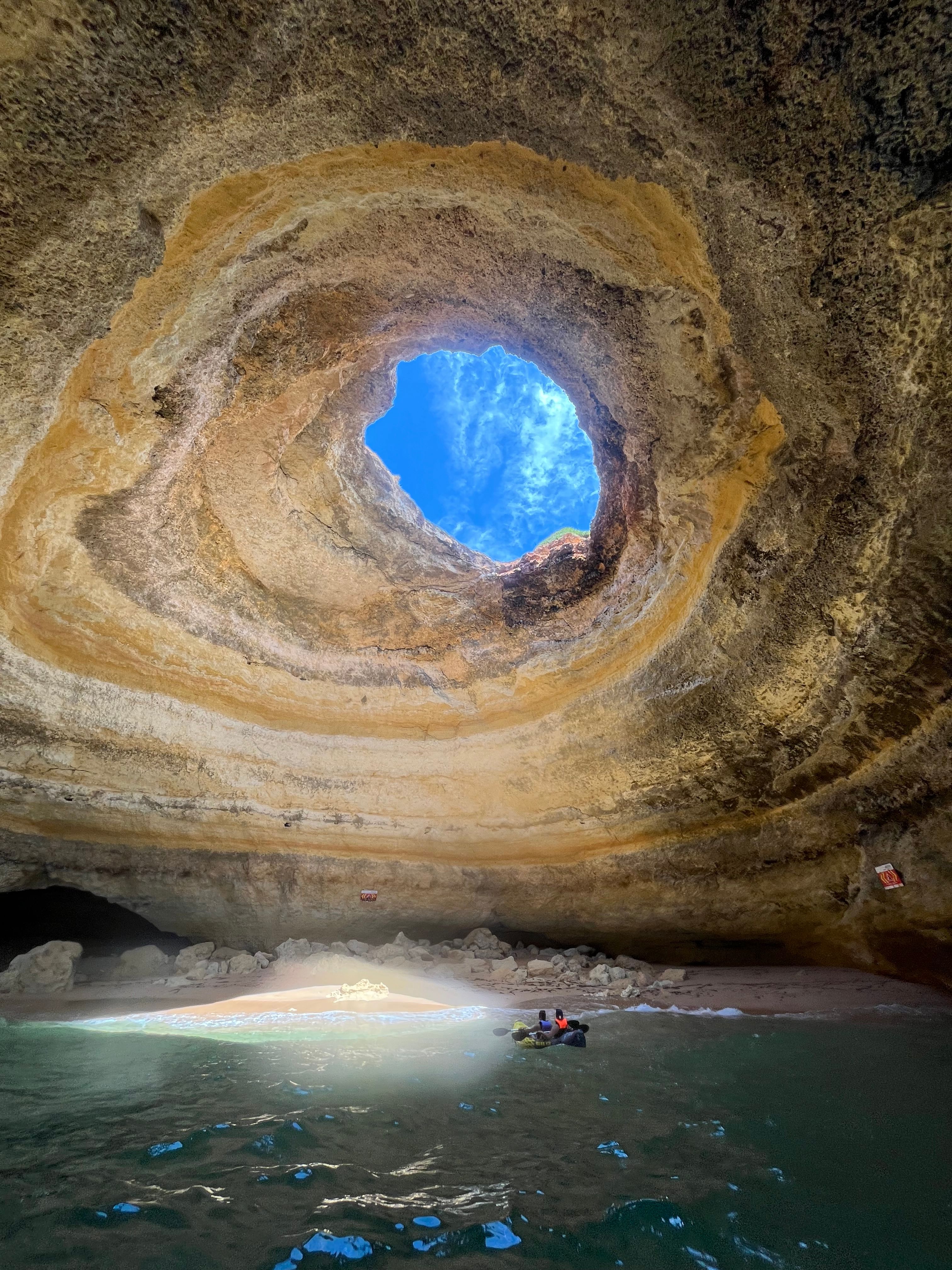 Beautiful view inside the natural rock formation Benagil Cave, Algarve, Portugal, with stunning sunlight.