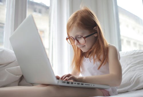Photo Of Child Using Laptop