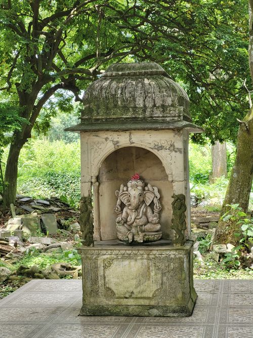 Free Ancient Ganesh shrine amidst dense forest, exuding tranquility and spiritual ambiance. Stock Photo