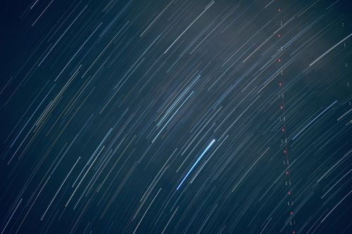 Free Mesmerizing long exposure photo capturing vivid star trails across a clear night sky. Stock Photo