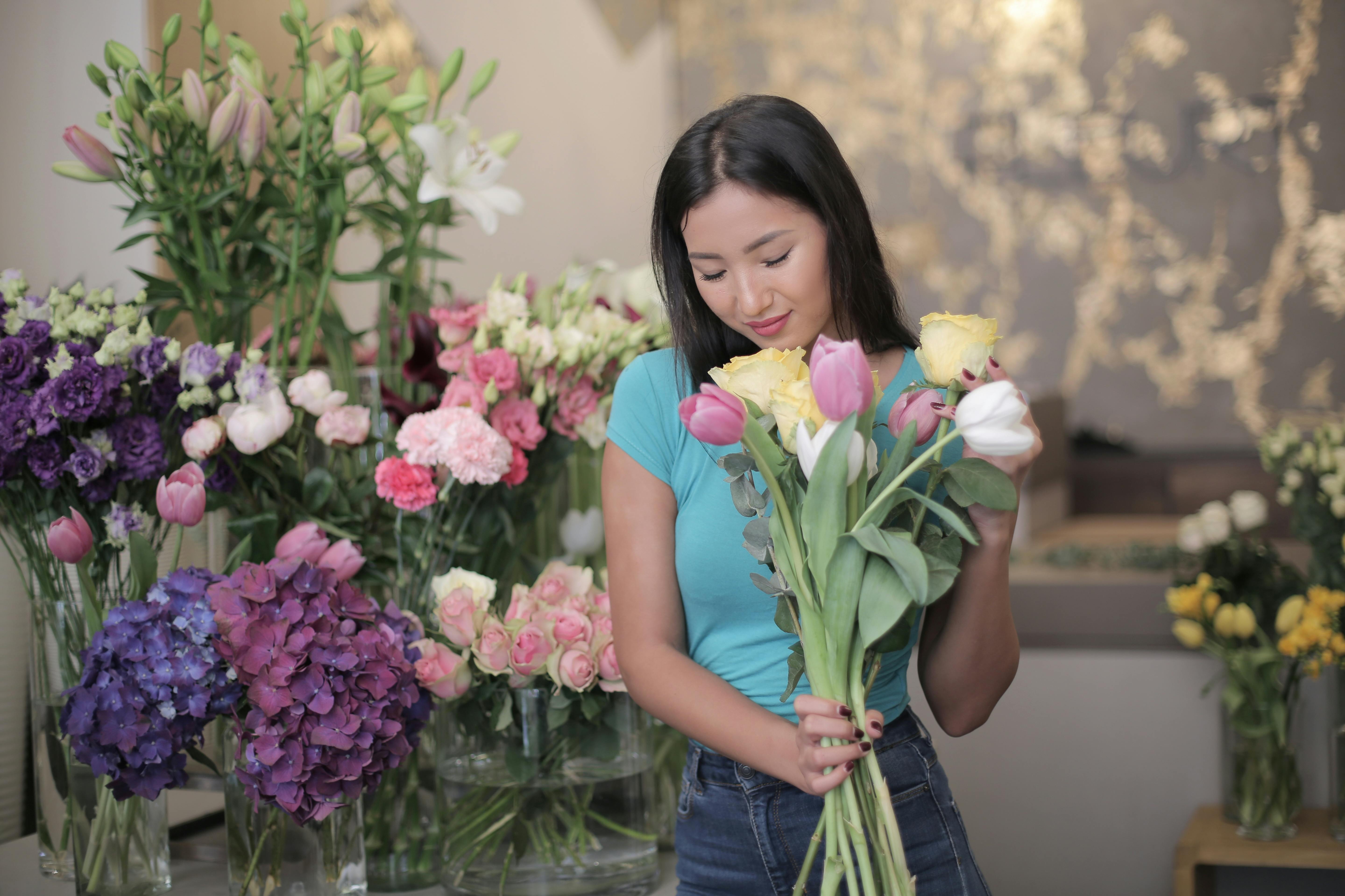 Photo Of Woman Holding Flowers Free Stock Photo