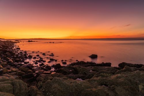 Free Beautiful view of the sunset over a rocky coastline in Melbourne, Australia. Stock Photo