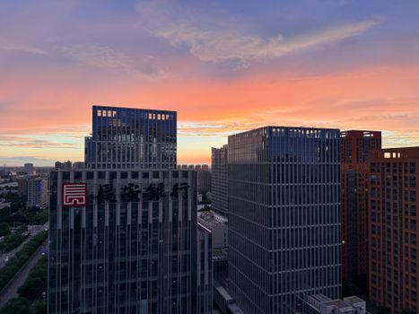 Breathtaking sunset casts vibrant hues over modern skyscrapers in Xi'an, capturing the city's urban skyline at dusk.
