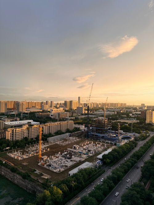 Free Aerial cityscape of Xi'an showing construction and skyline during sunset with vibrant colors. Stock Photo