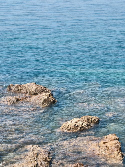 Free Tranquil ocean view with rocks and crystal clear turquoise water invoking peace and serenity. Stock Photo