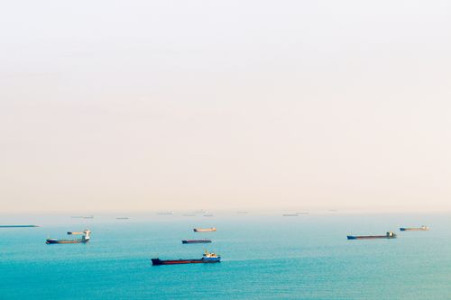 Free Peaceful scene of cargo ships floating on calm sea under clear sky in Samsun, Turkey. Stock Photo