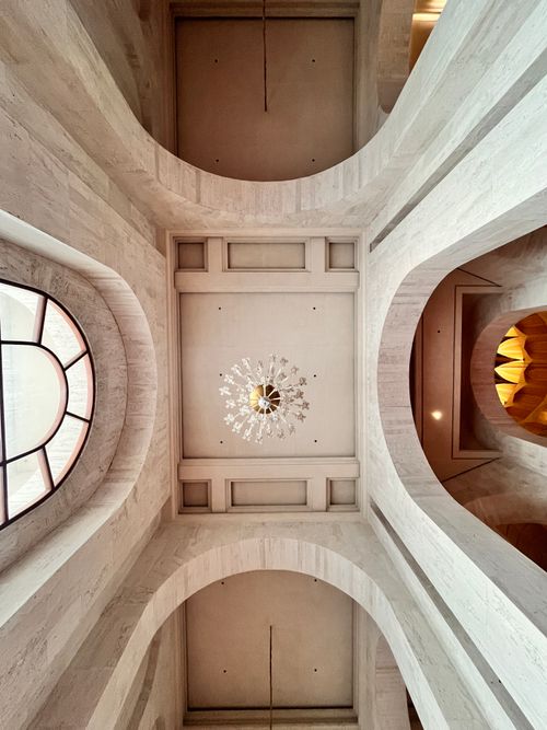 Free Stunning interior view of an architectural archway with a central chandelier and elegant curves. Stock Photo
