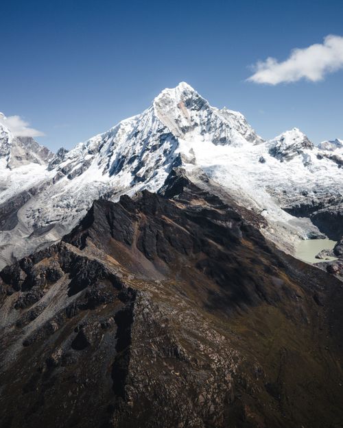 Free Explore the breathtaking beauty of snow-capped peaks and rugged terrain captured in an aerial view. Stock Photo