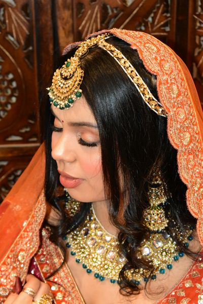 Bride in vibrant red outfit with jewelry