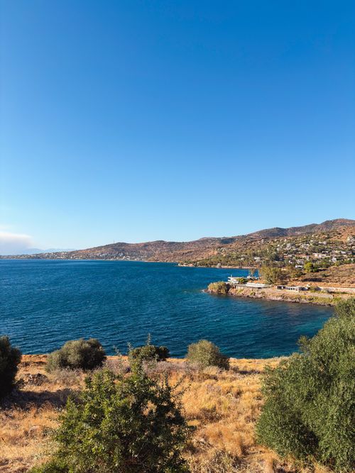 Free Breathtaking view of the Greek coastline with blue waters and hills under a clear sky. Stock Photo