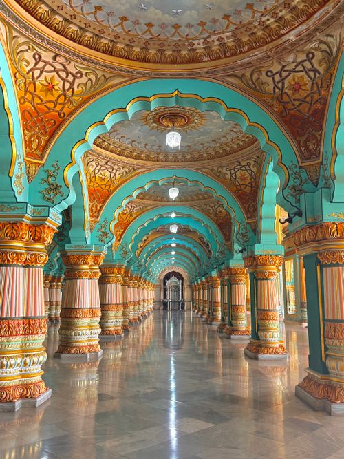 Free A stunning view of the ornate hallway in Mysore Palace, Mysuru, India, showcasing intricate architecture. Stock Photo