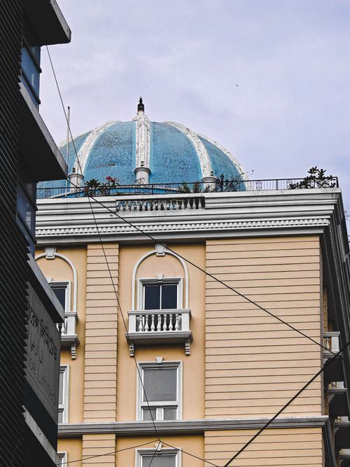 Free A striking building featuring a blue dome and classical architecture with balconies and detailed design. Stock Photo