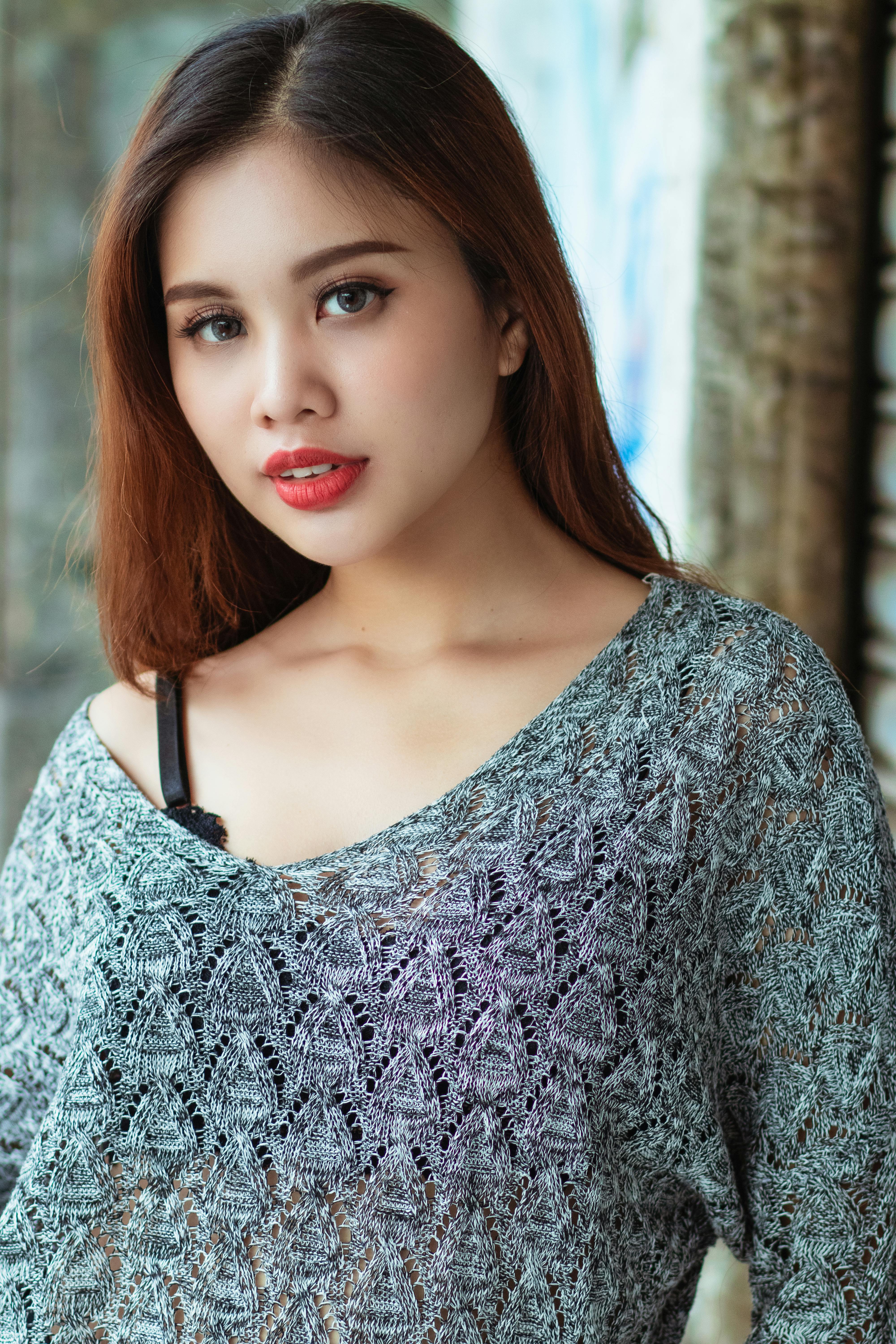 Stunning portrait of a young woman with red lips and a lace top. Perfect for beauty and fashion themes.