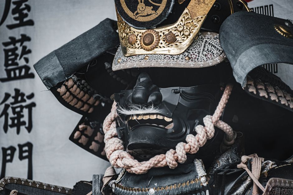 Close-up of a traditional samurai armor and helmet, highlighting intricate craftsmanship and design.
