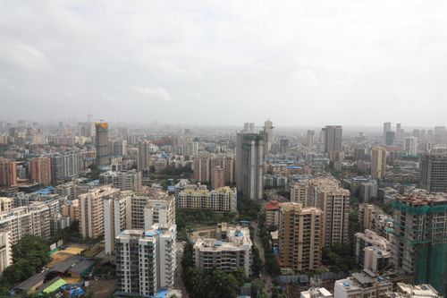 Free Vast urban skyline filled with high-rise buildings and cloudy sky. Stock Photo