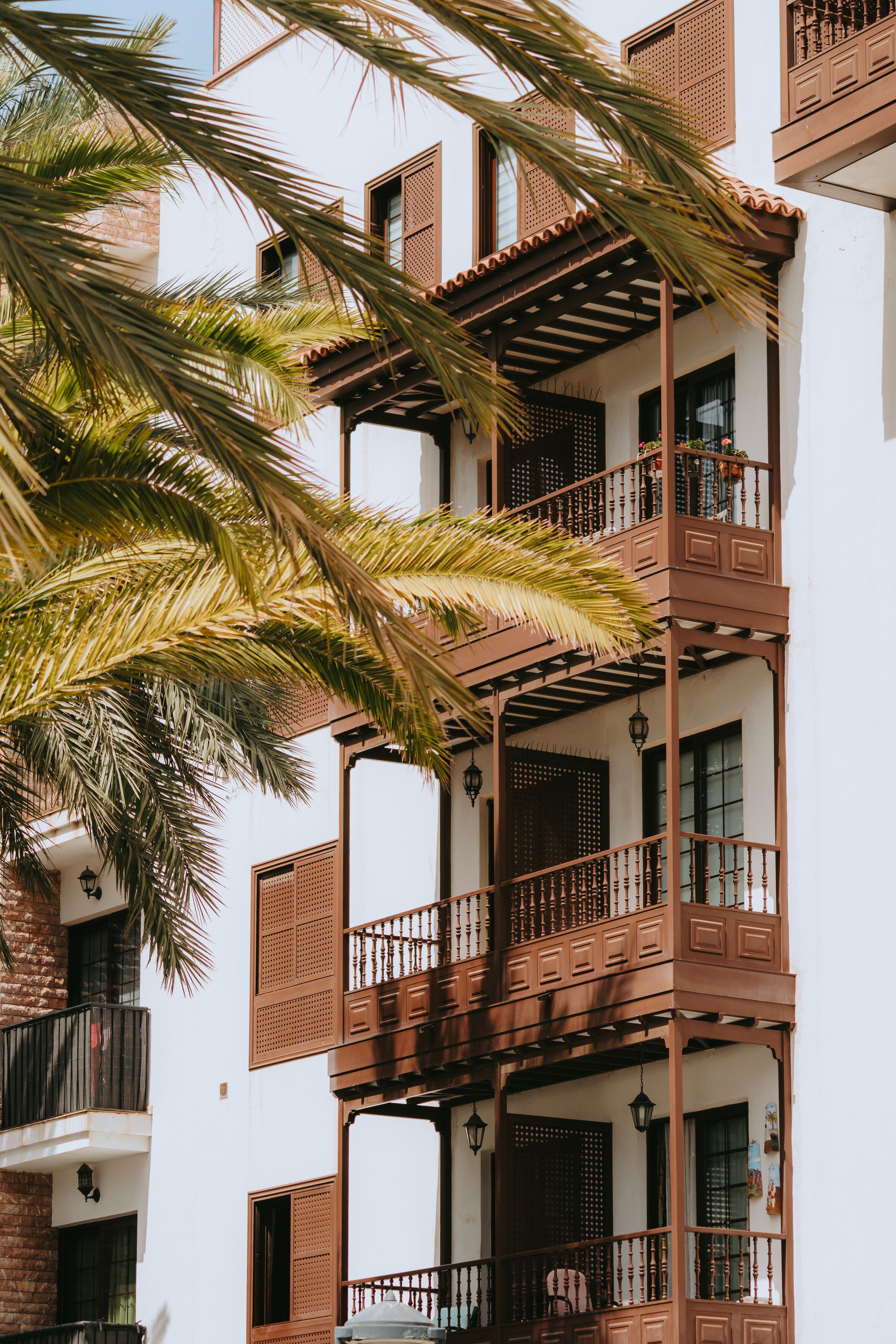 Colonial-style building with balconies in the Canary Islands under a sunny sky.