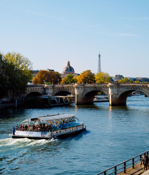 Free A scenic boat tour on the Seine River in Paris with a view of the Eiffel Tower. Stock Photo