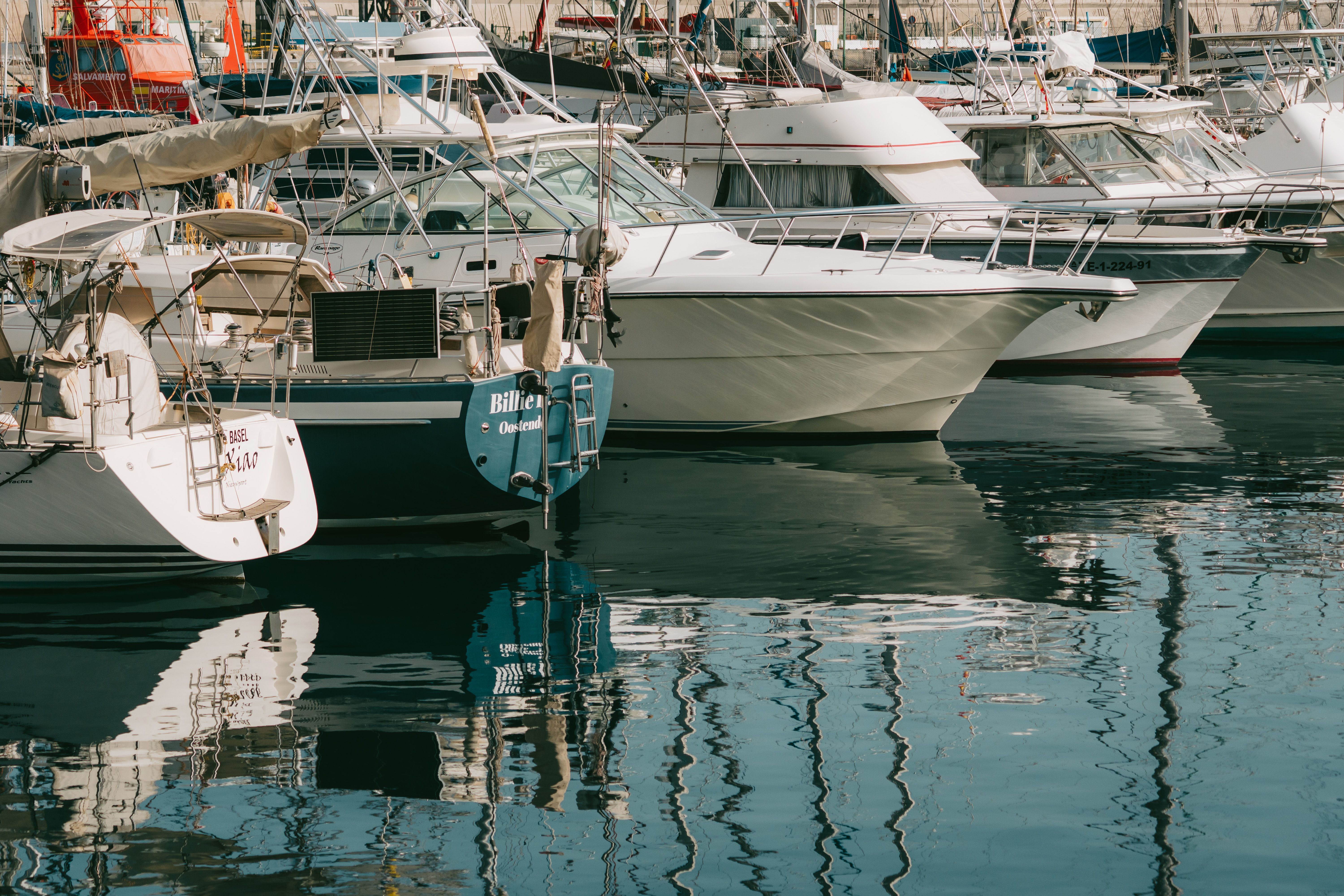 A scenic view of yachts moored in San Sebastián de La Gomera's serene harbor, Canary Islands.