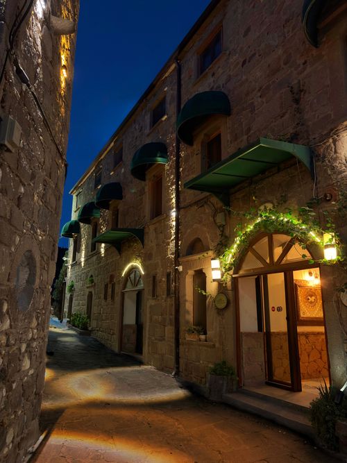 Free Quiet night view of a charming street in Assos, Türkiye, illuminated by warm lights. Stock Photo