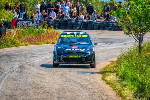 Free Intense car rally action in Ritsona, Greece showcasing dynamic driving and enthusiastic crowd. Stock Photo