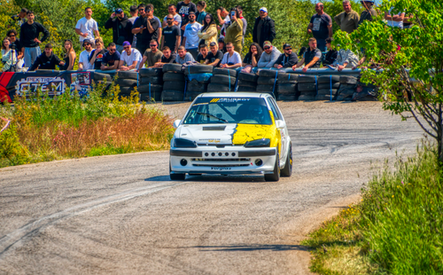 Free Dynamic rally car taking a curve at a race event in Ριτσώνα, thrilling spectators. Stock Photo