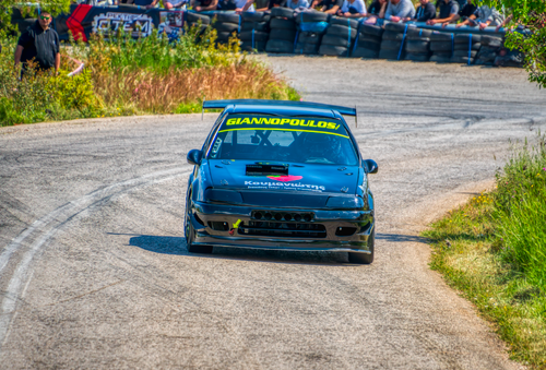 Free Dynamic shot of a racing car on a winding track in Ριτσώνα, Greece. Stock Photo