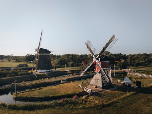 Free A picturesque scene of traditional Dutch windmills set against a tranquil landscape in Oud Zuilen, Utrecht. Stock Photo
