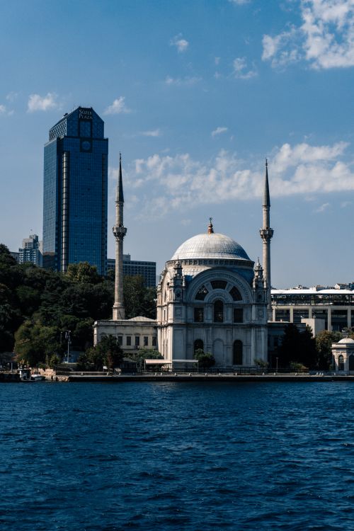 Free View of Ortaköy Mosque with a modern skyscraper in İstanbul, Turkey over the Bosphorus. Stock Photo