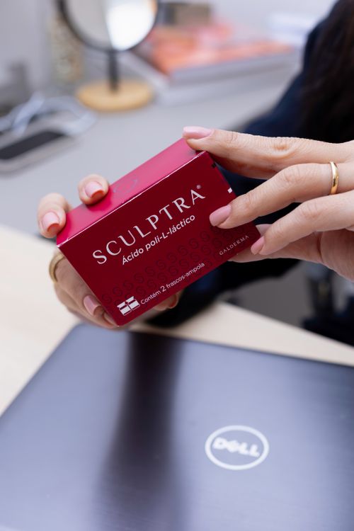 Free Hands holding a Sculptra aesthetic box in a modern clinic in Belo Horizonte. Stock Photo