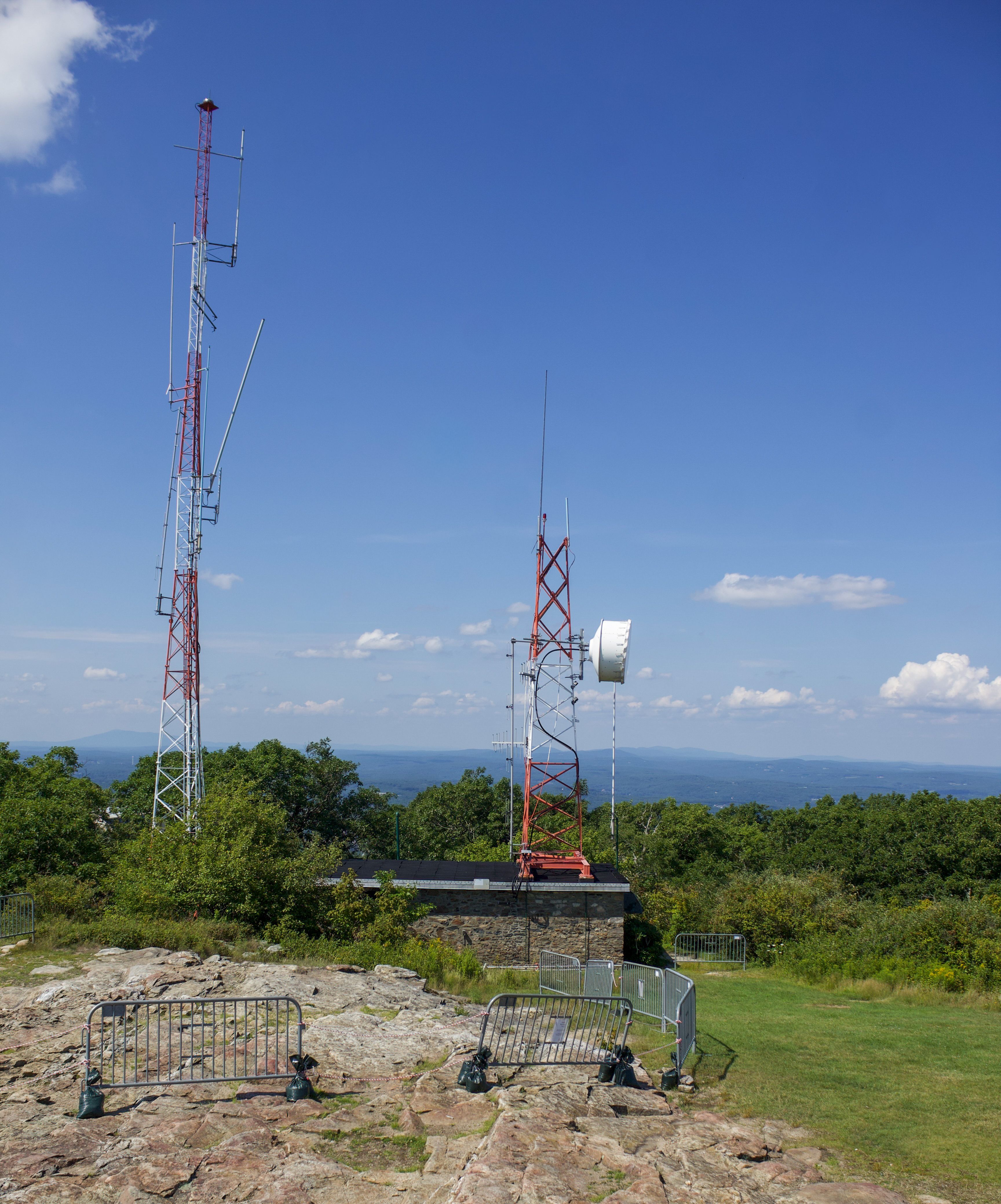View of communication towers atop Mount Wachusett under a clear sky.