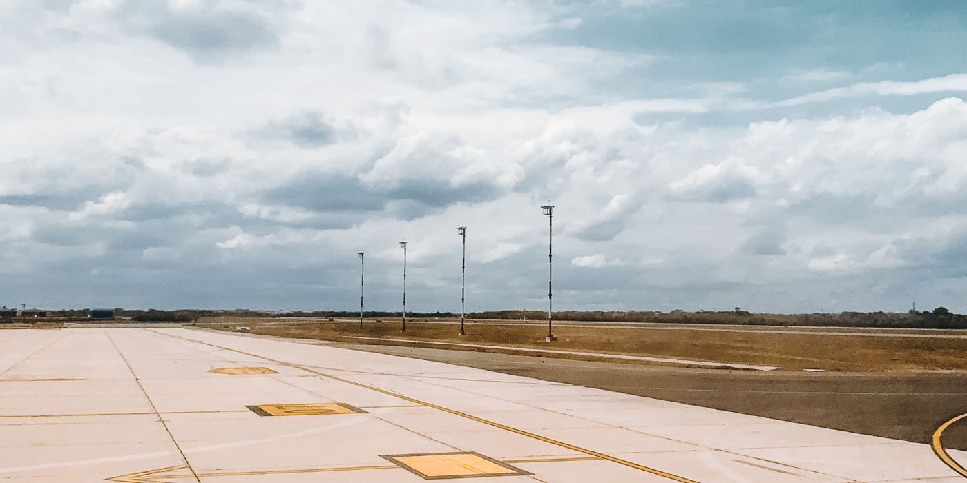 Airport runway under an overcast autumn sky at the start of fall travel season