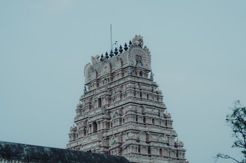 Free A stunning view of a Hindu temple's intricate architectural details against a clear sky. Stock Photo