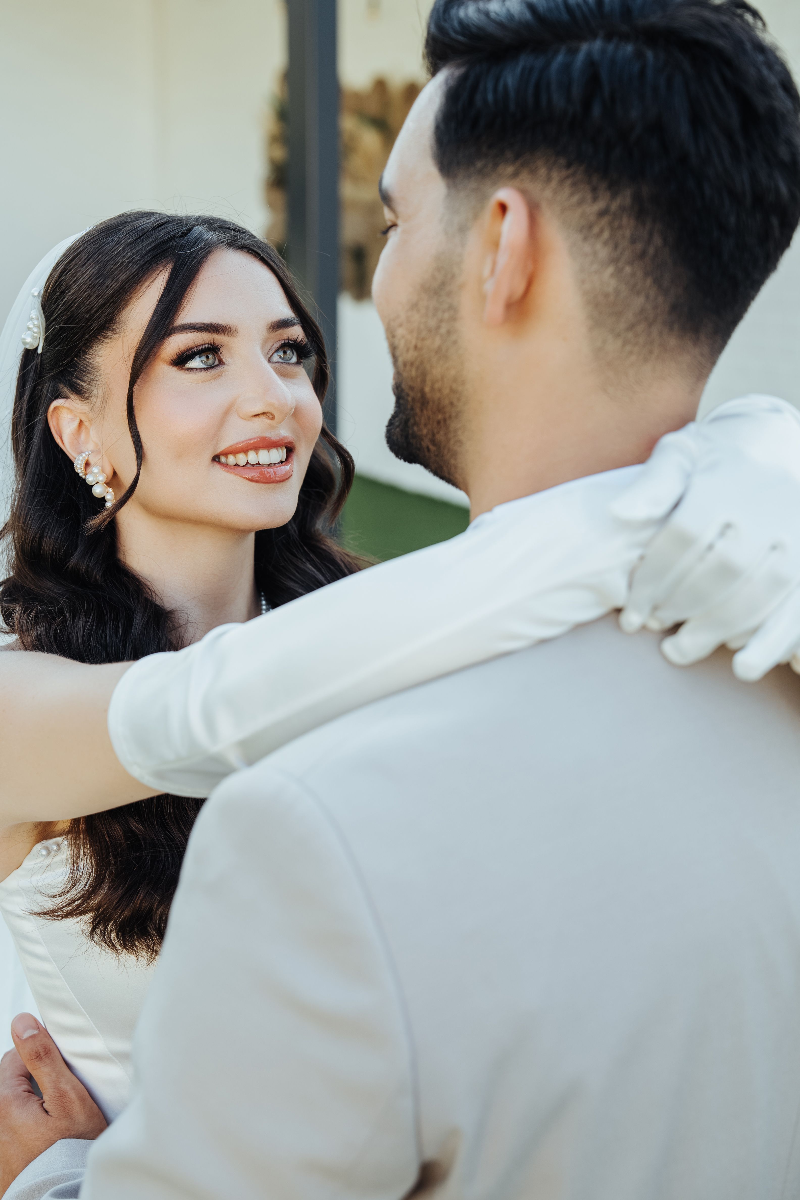 Elegant bride and groom sharing a tender moment outdoors in Antalya.