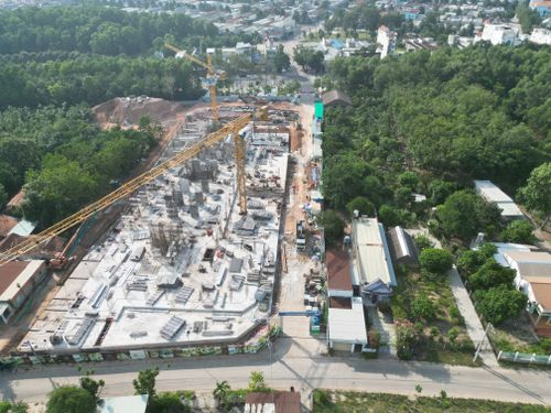 Free Aerial shot of a construction site amidst lush greenery in Ho Chi Minh City, Vietnam. Stock Photo