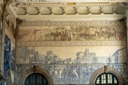 Free Intricate tile murals depicting historical scenes at São Bento Railway Station. Stock Photo