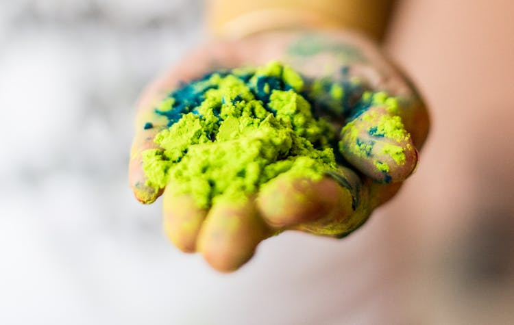 Person Holding Green Powder