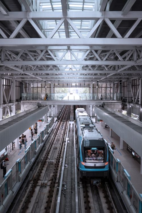 Free Aerial view of a busy metro station interior in New Taipei City showcasing the modern architecture and transit system. Stock Photo